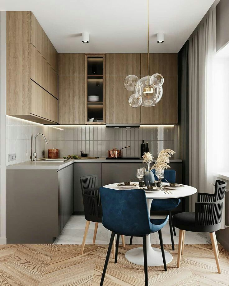 Warna earthy tone untuk kitchen set dan lemari cocok bagi anda yang suka dengan kesan elegan di area dapur. Tambahkan juga lampu gantung dengan desain bola kaca dan beraksen emas yang minimalis namun menarik