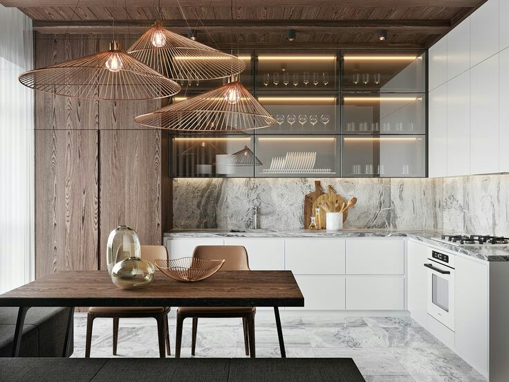 Material kayu dan batu marmer menyatu sempurna pada model dapur sederhana di bawah ini. Lemari dapur yang sleek, glossy berwarna putih terlihat mengimbangi rak kaca elegan bagian atas yang juga dilengkapi pencahayaan