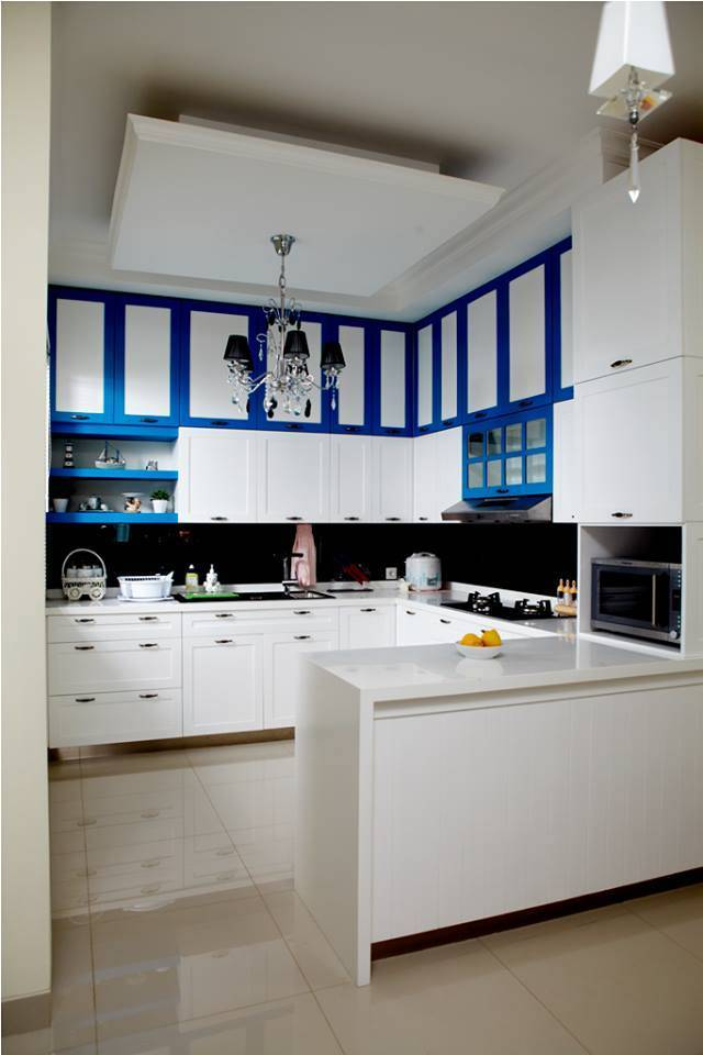 Agar anda bisa menghindari kesan terlalu simpel pada dapur dengan dominasi warna putih, anda dapat menambahkan sedikit warna pada lemari bagian atas seperti warna biru contohnya. Lampu gantung yang cantik ini juga jangan terlupakan