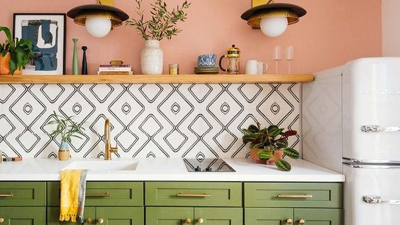 Jangan pernah takut untuk mengkombinasikan warna untuk area dapur. Seperti warna peach yang soft dapat menyatu sempurna bersama warna hijau tua pada lemari dapur dan aksen putih di countertopnya. Untuk wallpaper pilih yang bercorak garis dengan warna netral